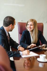 Wealth Management for entrepreneurs and executives represented by an image of 2 financial advisors working at a conference table