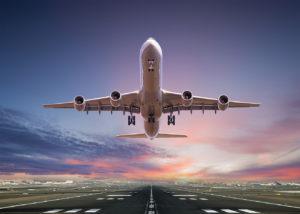 Wealth Management for Airline Executives and Pilots represented by a close up image of the underside of a passenger jet taking off.