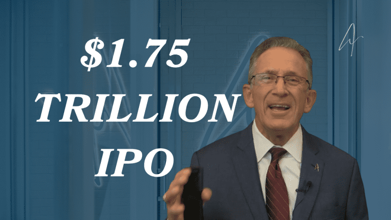 Man in suit and glasses discussing a $1.75 trillion IPO, holding a smartphone, speaking to camera.