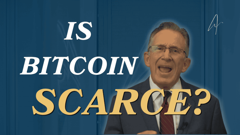 Man in suit and glasses speaking beside bold text reading Is Bitcoin Scarce? on a blue background